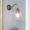 Newton Fluted Wall Light with Carrick Arm in Antiqued Brass