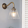 Newton Fluted Wall Light with Carrick Arm in Antiqued Brass