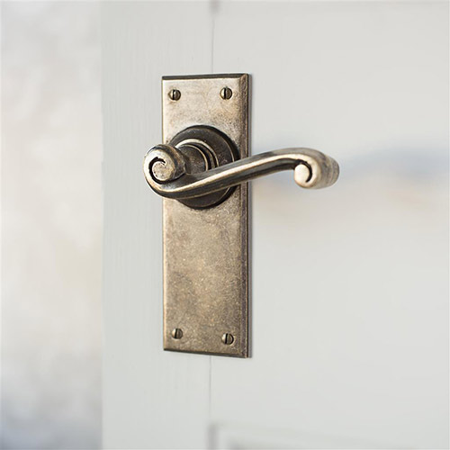 Regency lever handle in antiqued brass