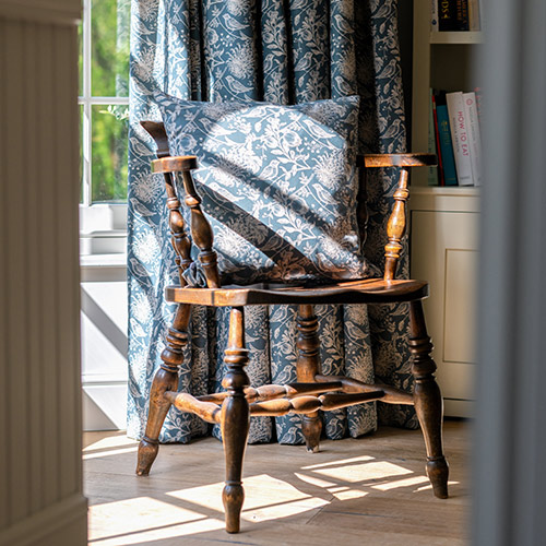 Cushion and curtains in Indigo Woodland